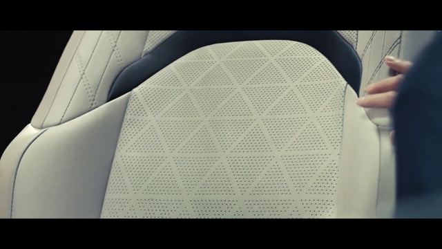 Video Reference: Hood, Sleeve, Gesture, Rectangle, Font, Automotive tire, Tints and shades, Grille, Circle, Pattern