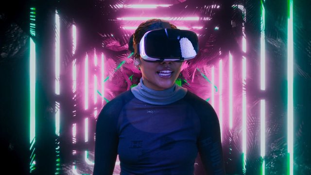 Video Reference: virtual reality, VR headset, person, neon lights, futuristic, technology, tunnel, cyberpunk, portrait, digital experience, immersive, glowing, pink, purple, green, modern