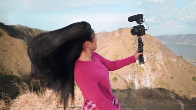 Video Reference: Sky, Vertebrate, Camera, Cloud, Temple, Travel, Mountain, Happy, People in nature, Video camera