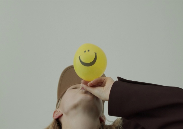 Video Reference: Head, Hand, Arm, Mouth, Smile, Happy, Gesture, Emoticon, Headgear, Smiley