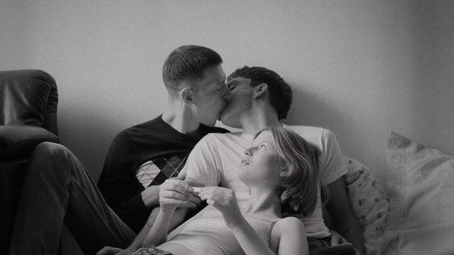 Video Reference: black and white, indoor, kissing, couple, three people, couch, bedroom, intimate, portrait, relationship, lifestyle, youth, monochrome, romantic, resting