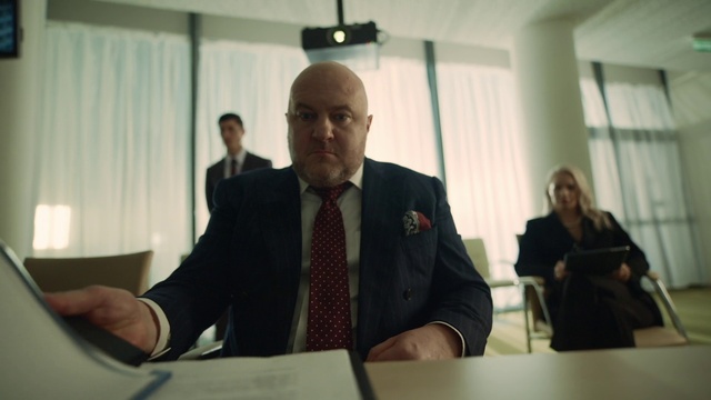 Video Reference: Furniture, Table, Coat, Tie, Chair, Gesture, Suit, Microphone, Blazer, White-collar worker