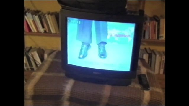 Video Reference: CRT TV, television, indoor, bookshelf, remote control, living room, video screen, shoes, legs, retro, home, dim light