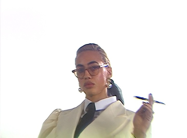 Video Reference: Glasses, Vision care, Eyewear, Dress shirt, Gesture, Collar, Audio equipment, Blazer, Formal wear, White-collar worker