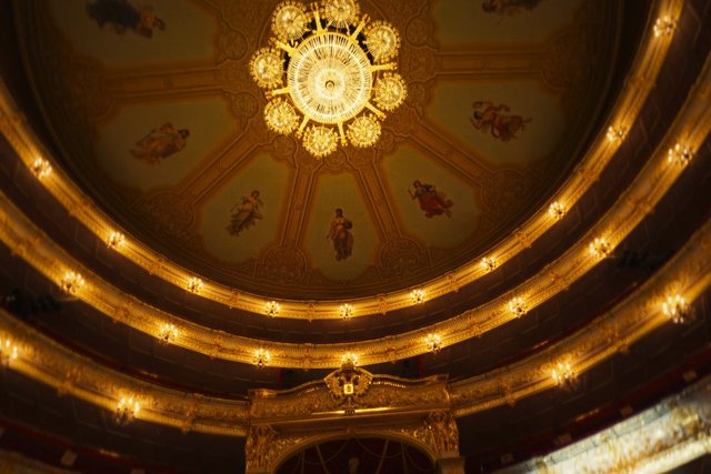 Video Reference: theater, opera house, ceiling, chandelier, ornate, gold, interior, balcony, architecture, decorative, historic, luxury, auditorium, baroque, ornament, interior design