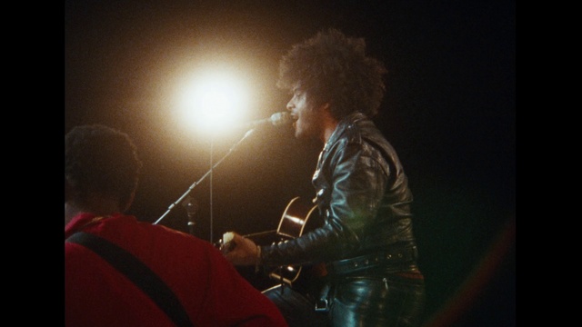 Video Reference: Microphone, Flash photography, Artist, Entertainment, Music, Audio equipment, Musician, Performing arts, Leather jacket, Music artist