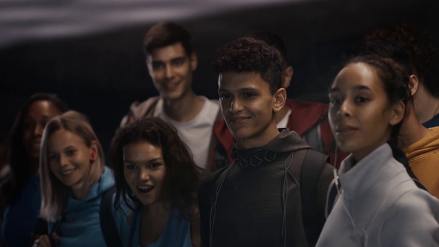 Video Reference: Hair, Face, Smile, Head, Eye, Flash photography, T-shirt, Jacket, Entertainment, Fashion design