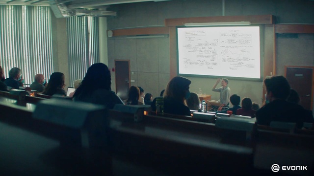 Video Reference: Table, Chair, Desk, Projection screen, Technology, Event, Public speaking, Electronic device, Service, Job