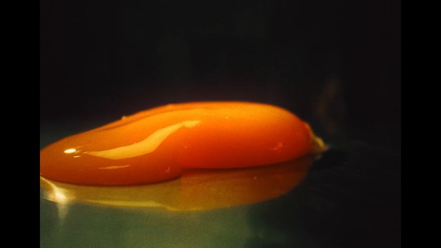 Video Reference: macro, close-up, orange, glossy, liquid, gel, abstract, reflection, dark background, texture, surface, minimal, studio lighting
