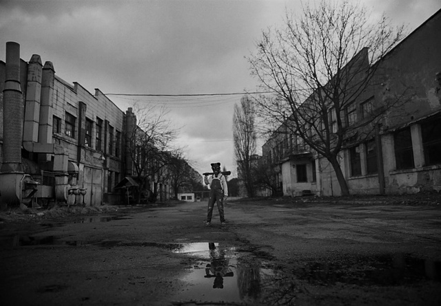 Video Reference: Building, Sky, Cloud, Atmosphere, Window, Road surface, Black, Infrastructure, Black-and-white, Plant