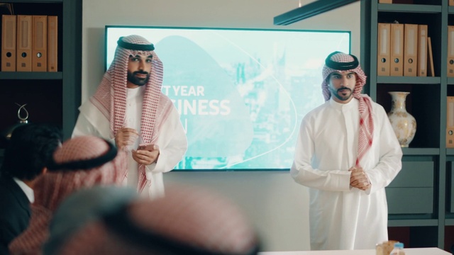 Video Reference: Microphone, Hat, Community, Beard, Adaptation, Event, Eyewear, Youth, Audio equipment, Room