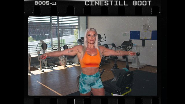 Video Reference: gym, fitness, woman, posing, workout, exercise equipment, indoor, sportswear, portrait, strength, training, sunlight, blonde hair, athletic, casual, film frame
