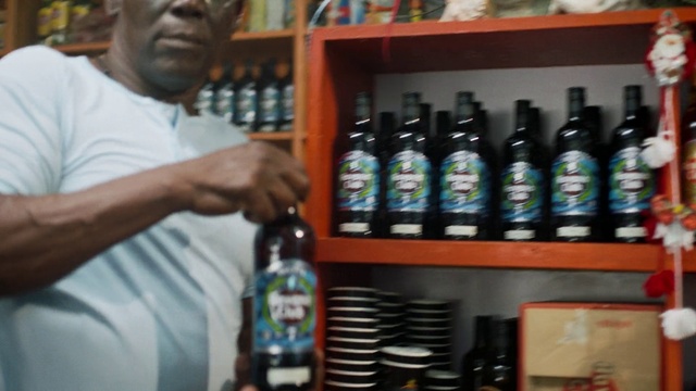 Video Reference: Bottle, Product, Drinking establishment, Barware, Glass bottle, Shelf, Alcoholic beverage, Drink, Hat, Bottle cap