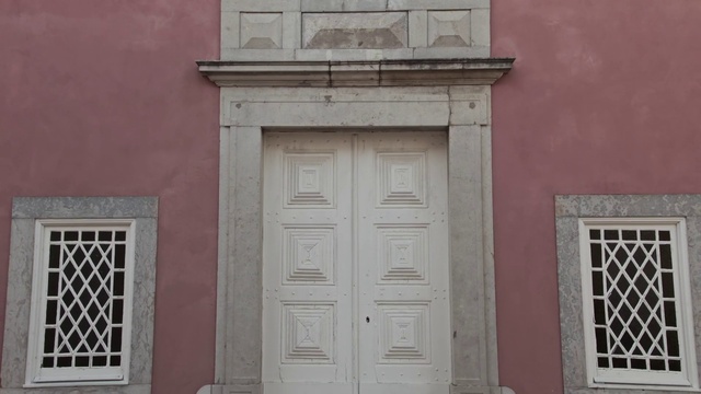 Video Reference: Fixture, Wood, Building, Home door, Material property, Door, Window, Facade, Symmetry, Tints and shades