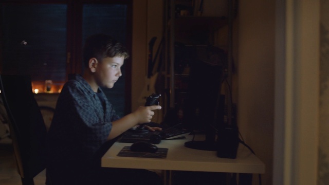 Video Reference: Curious, Table, Flash photography, Desk, Office equipment, Darkness, Input device, Personal computer, Audio equipment, Wood