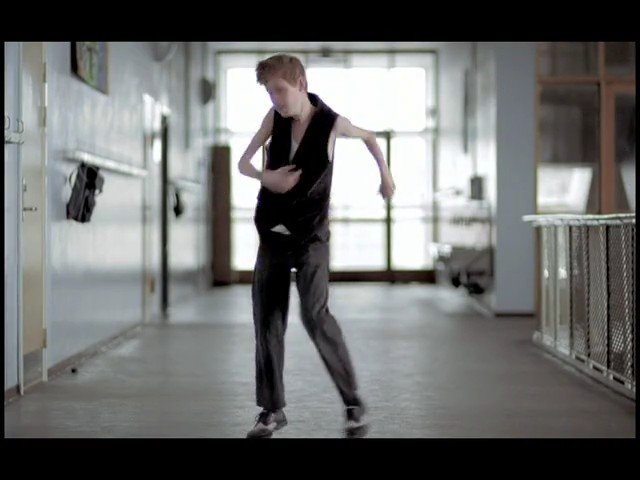 Video Reference: person, dance, hallway, indoor, bright, windows, motion, pose, corridor, building, casual clothes, standing