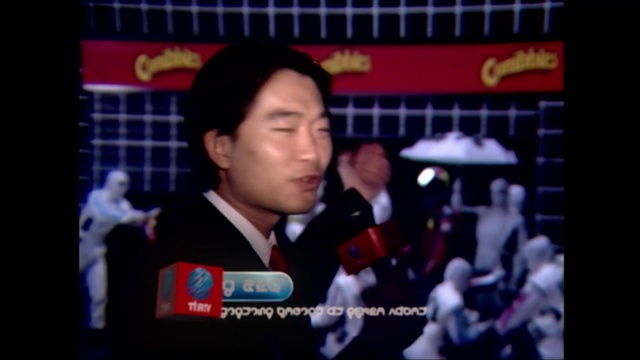 Video Reference: Microphone, Television program, News, Event, Display device, Television presenter, Spokesperson, Official, Journalist, Suit