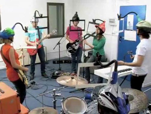 Video Reference: music, band, rehearsal, practice, indoor, guitar, keyboard, drums, microphones, group, studio, performance, helmets