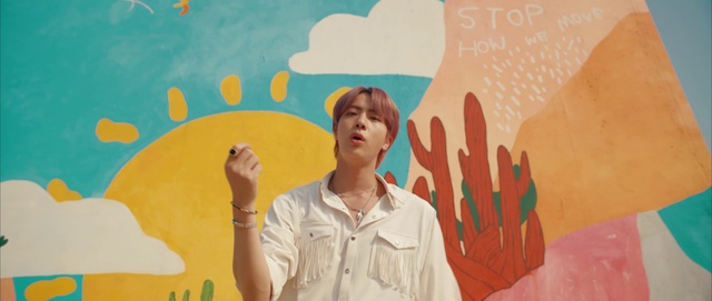 Video Reference: Facial expression, World, Sleeve, Organism, Happy, Gesture, Yellow, Finger, Art, Wall
