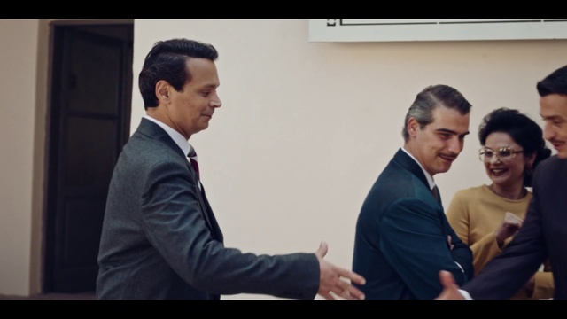 Video Reference: Smile, Greeting, Coat, Gesture, Suit, Tie, Collar, Blazer, Formal wear, White-collar worker