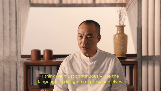 Video Reference: man, interview, indoor, speaking, subtitles, minimalist, interior, decorative vase, shelves, portrait, talking head, home decor, white shirt
