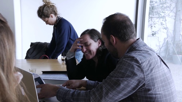 Video Reference: Table, Computer, Laptop, Personal computer, Interaction, Engineering, White-collar worker, Smile, Event, Conversation