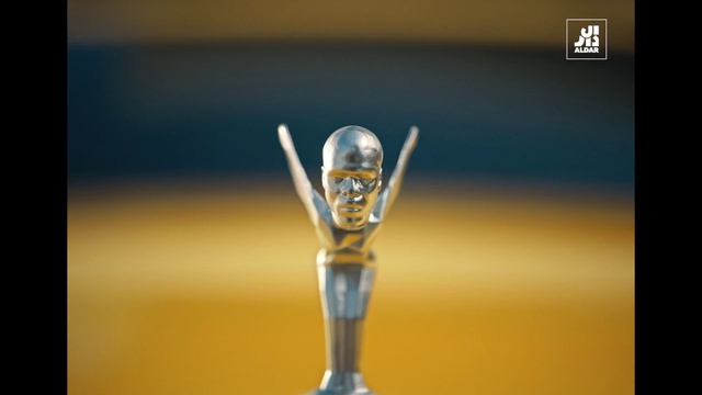 Video Reference: Gesture, Font, Player, Tournament, Macro photography, Art, Trophy, Competition event, Electric blue, Championship