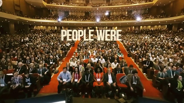 Video Reference: Musical instrument accessory, Fan, Crowd, Suit, Entertainment, Chair, Event, Government, Stage, Performing arts center