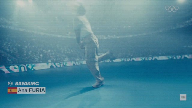 Video Reference: breakdance, breaking, sports, competition, arena, dancer, blue floor, broadcast, olympics, event graphics, crowd, performance, indoor, lower third