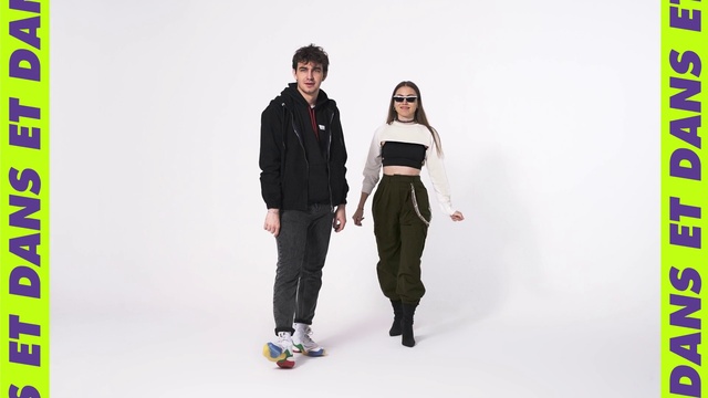 Video Reference: Shoulder, Flash photography, Sleeve, Waist, Gesture, Knee, Fashion design, Black hair, T-shirt, Bag