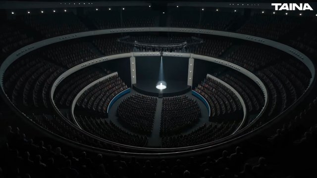 Video Reference: auditorium, theater, stage, spotlight, audience, crowd, interior, circular, seating, event, performance, venue, dark, wide shot