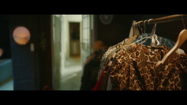 Video Reference: Sleeve, Flash photography, Fashion design, Event, Font, Darkness, Visual arts, Clothes hanger, Street fashion, Room