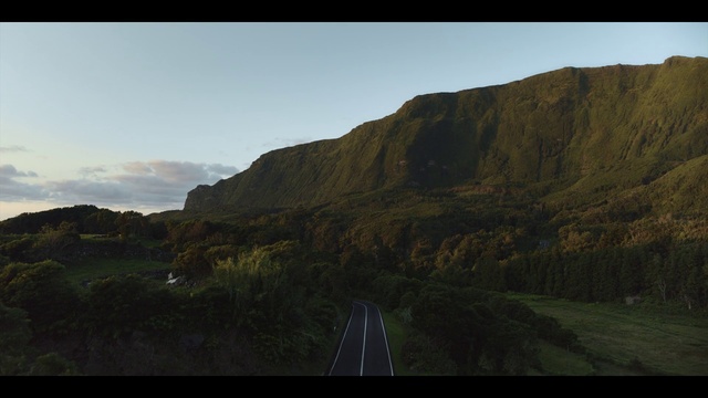Video Reference: Sky, Cloud, Mountain, Natural landscape, Highland, Slope, Grass, Terrain, Road surface, Asphalt