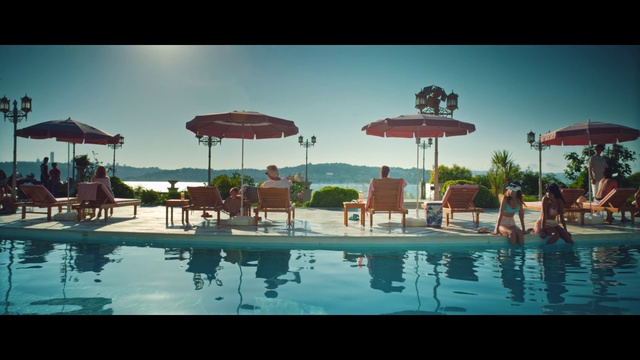 Video Reference: Water, Sky, Plant, Umbrella, Swimming pool, Azure, Outdoor furniture, Building, Shade, Chair