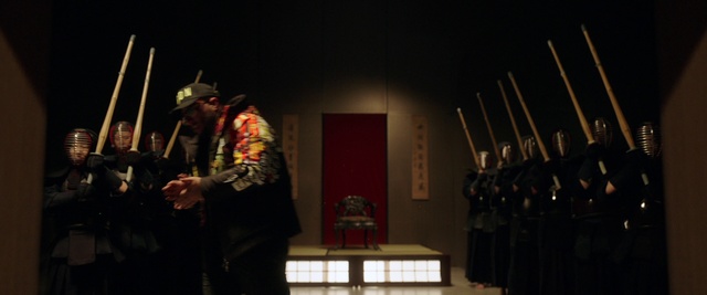 Video Reference: Hat, Fedora, Performing arts, Entertainment, Sun hat, Event, Music, Curtain, Darkness, Flag