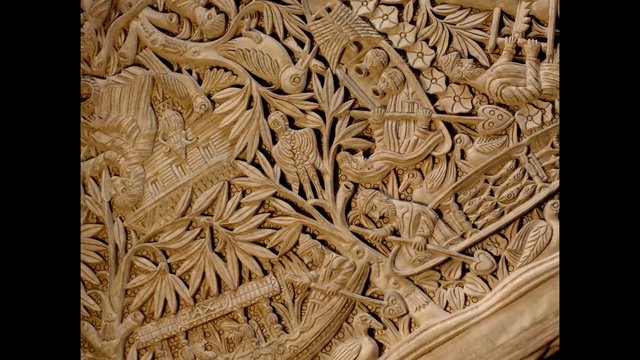Video Reference: wood carving, relief, ornamental, floral pattern, birds, foliage, handcrafted, decorative art, texture, close-up, traditional design, artisan, pattern, sculpture