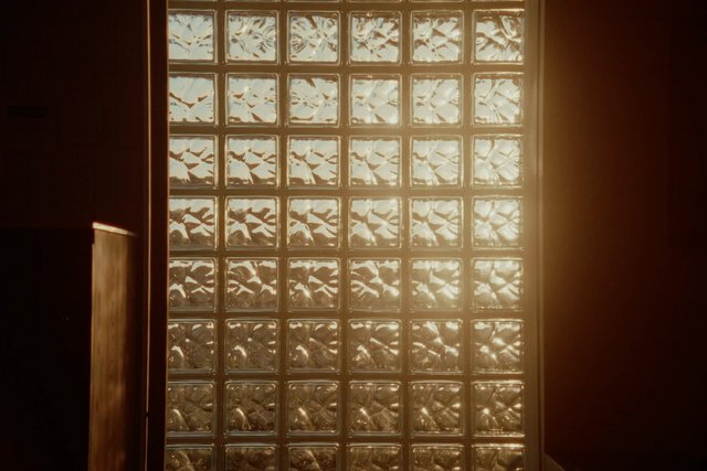 Video Reference: frosted glass, glass blocks, sunlight, warm light, interior, window, backlit, shadows, wall, doorway, abstract, texture, minimal, architecture, indoor, golden hour