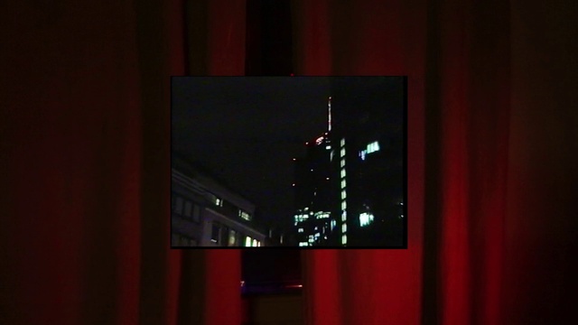 Video Reference: Building, Skyscraper, Rectangle, Red, Tints and shades, Display device, Art, Tower block, Glass, Event