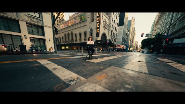 Video Reference: Building, Road surface, Window, Asphalt, Urban design, Sidewalk, Font, Road, Tints and shades, City