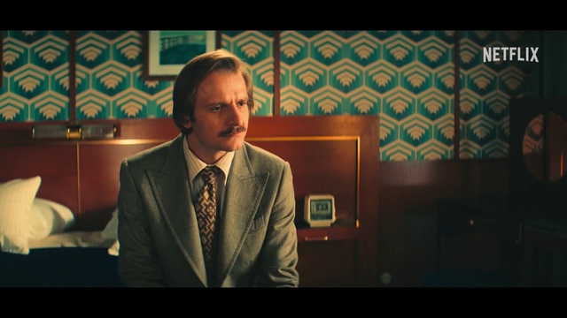 Video Reference: Tie, Suit, Blazer, Formal wear, Event, Audio equipment, Public speaking, Spokesperson, Dress shirt, Speech