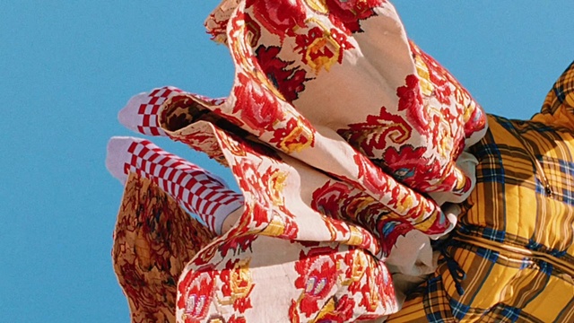 Video Reference: Sky, Sleeve, Red, Art, Pattern, Event, Peach, Tradition, Roof, Visual arts