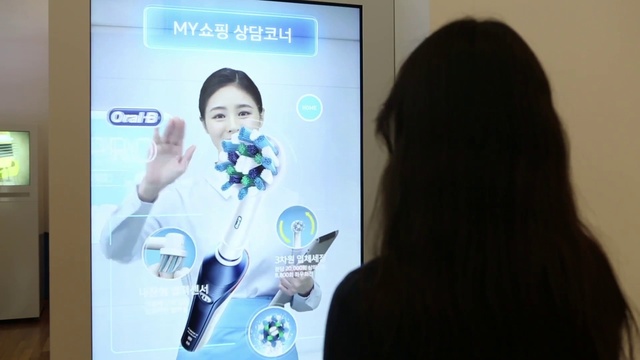 Video Reference: Hairstyle, Gesture, Gadget, Communication Device, Font, Suit, Electronic device, Public speaking, Technology, Event