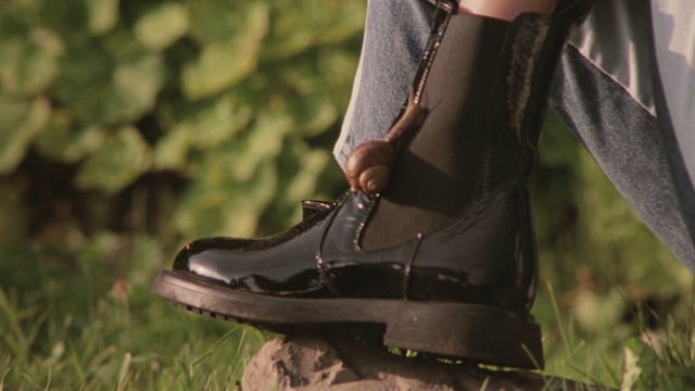 Video Reference: Sleeve, Outdoor shoe, Street fashion, Grey, Walking shoe, Grass, Sportswear, Fashion design, Blazer, Human leg