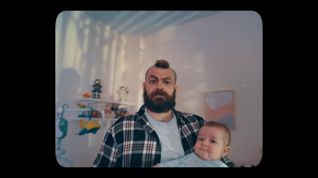 Video Reference: Photograph, Tartan, Beard, Television set, Flash photography, Plaid, Facial hair, Display device, Gadget, Baby
