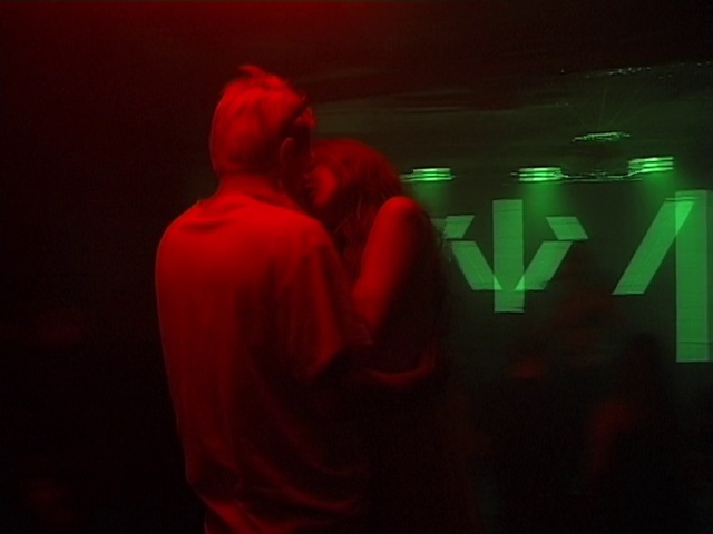 Video Reference: Gesture, Font, Entertainment, Magenta, T-shirt, Event, Visual effect lighting, Darkness, Neon, Performing arts