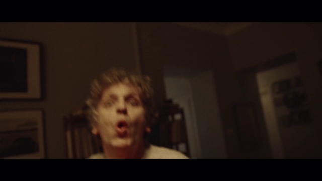Video Reference: Mouth, Jaw, Flash photography, Picture frame, Darkness, Event, Facial hair, T-shirt, Bangs, Surfer hair