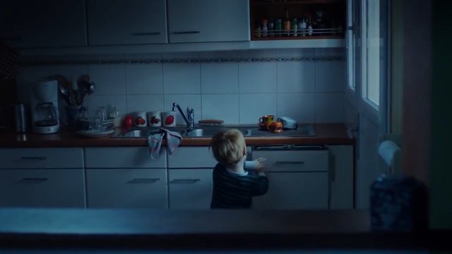 Video Reference: kitchen, child, indoor, home, sink, countertop, cabinets, dim light, morning, household, interior, family, window, appliances