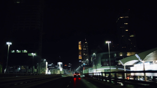 Video Reference: Building, Automotive lighting, Street light, Infrastructure, Sky, Road surface, Electricity, Skyscraper, Car, Asphalt