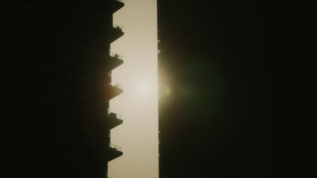 Video Reference: Building, Sky, Window, Tints and shades, City, Astronomical object, Horizon, Backlighting, Sun, Darkness