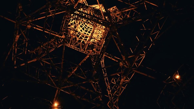 Video Reference: Lighting, Electricity, Amber, Sky, Tower, Triangle, Line, Symmetry, Overhead power line, Electrical supply